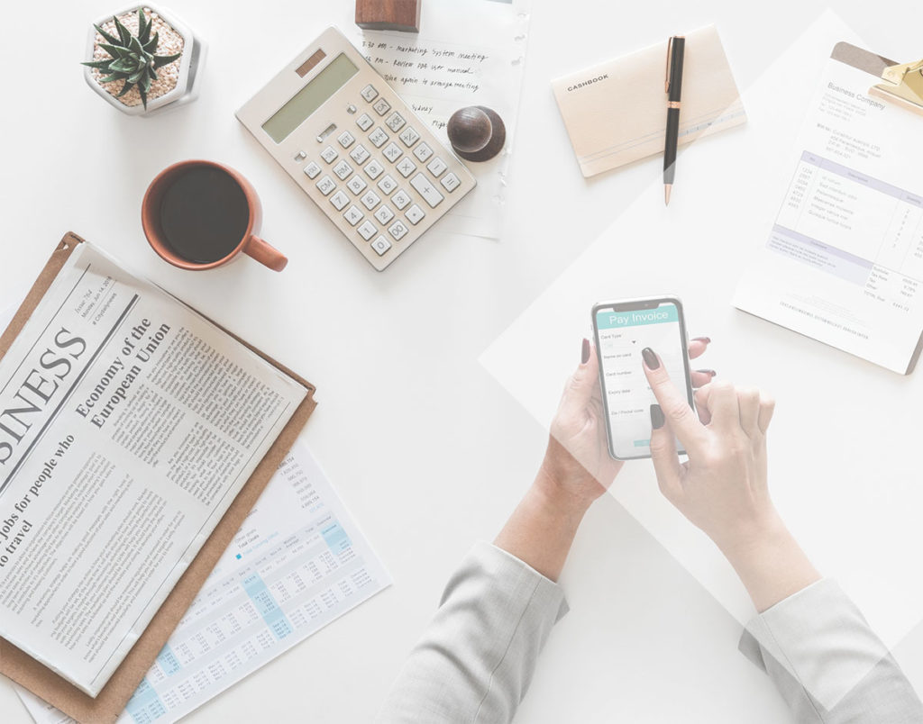 Desk with documents, coffee and phone